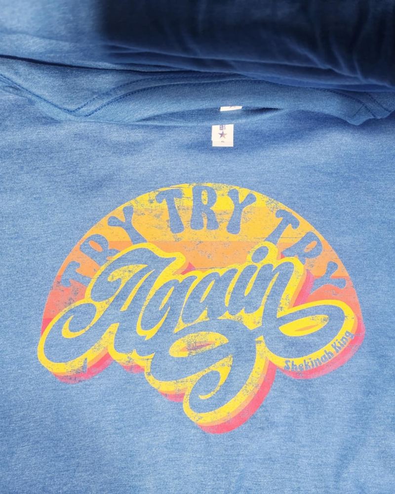 Heather blue hoodie with a retro distressed 'Try Try Try Again' design for Shekinah King
